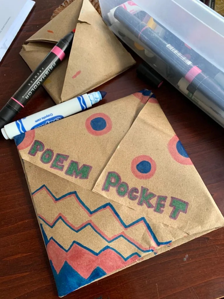 Pocket created from a brown paper back with Poem Pocket written on it and some decoration.