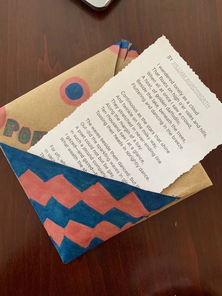 Paper bag pocket with poem nestled inside, half out.