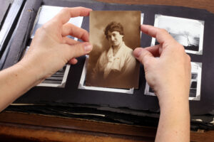 Hands holding a photo of a grandmother.