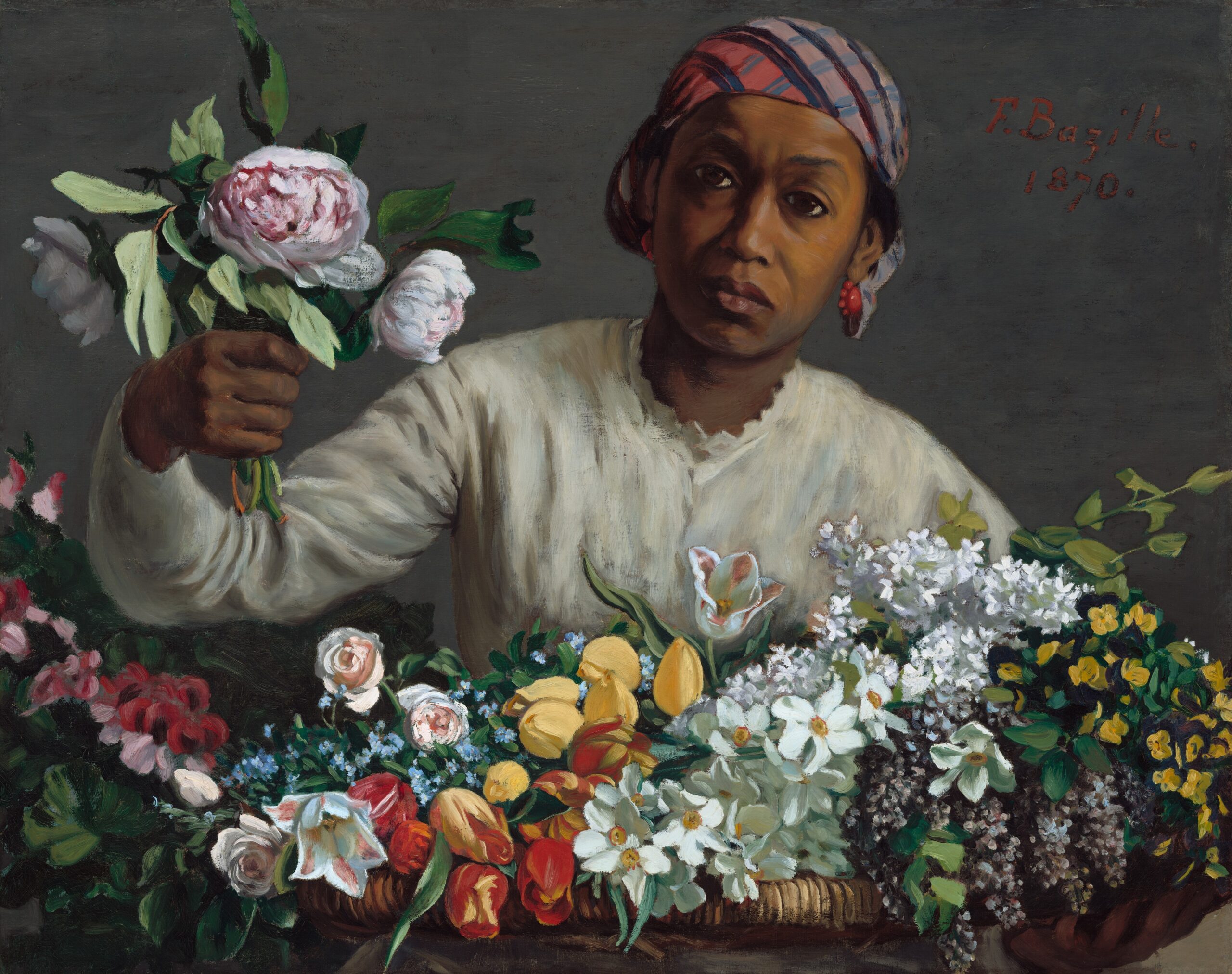 Young black woman in white dress with many flowers around her.